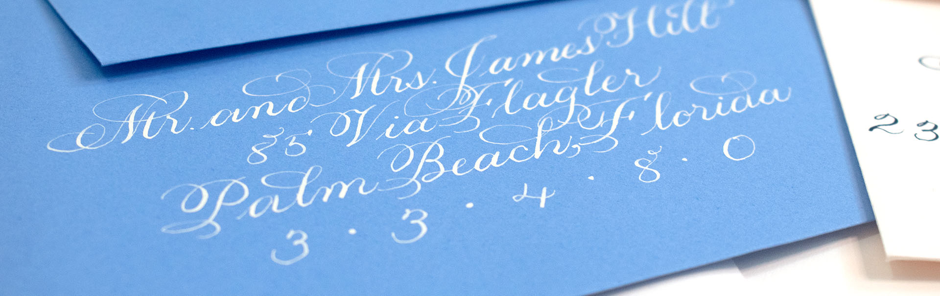 Cream envelope addressing calligraphy on azure blue envelopes